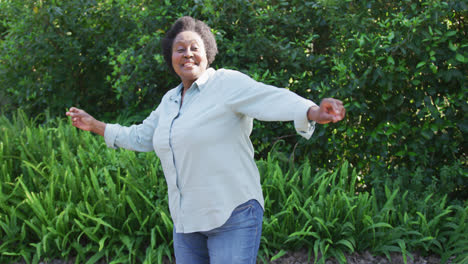 african american senior woman dancing in the garden