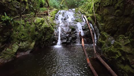 backward drone shot of lost waterfall on mahe island, seychelles