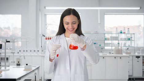 feliz científica india haciendo experimentos en un laboratorio