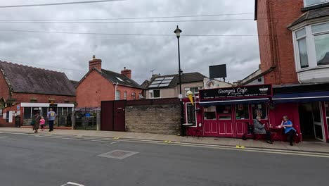 busy street with shops and pedestrians