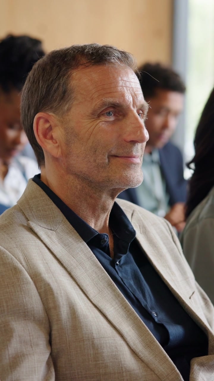Mature Businessman Listening Attentively During a Professional Meeting