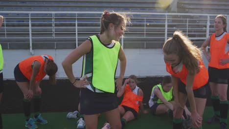 female hockey players warming up on the field