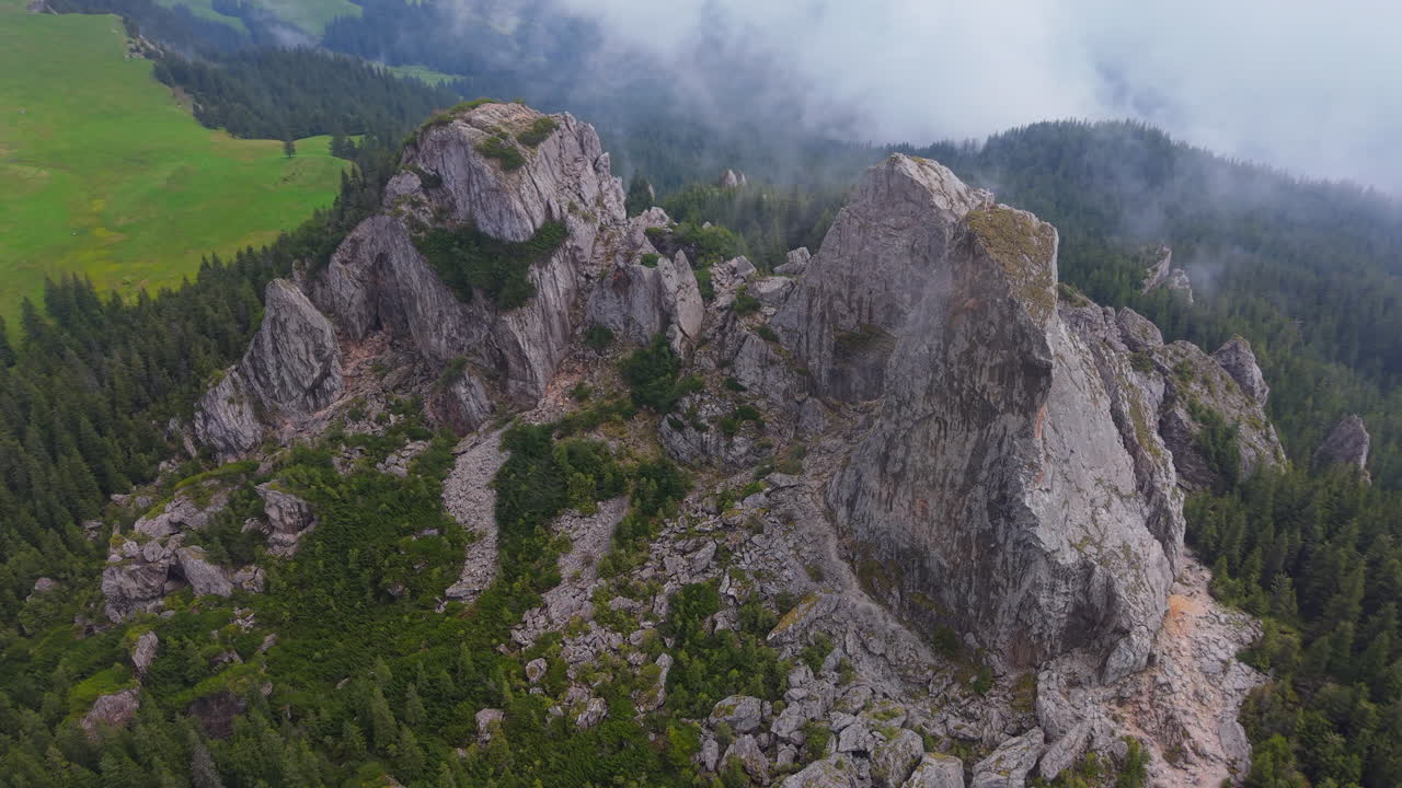 Low clouds covering Pietrele Doamnei, a geological reserve in Rarau Mountains, Eastern Carpathians, Romania
