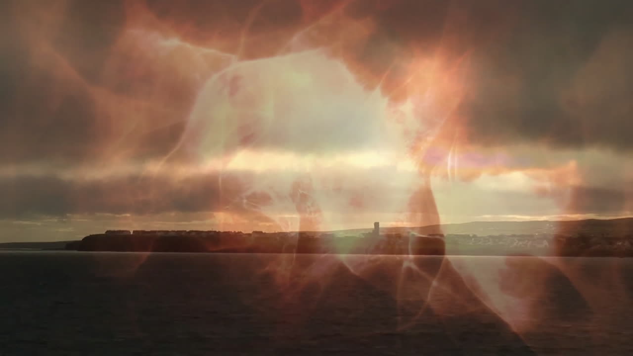 Sunset coastal landscape with fiery abstract animation shapes overlaying serene view