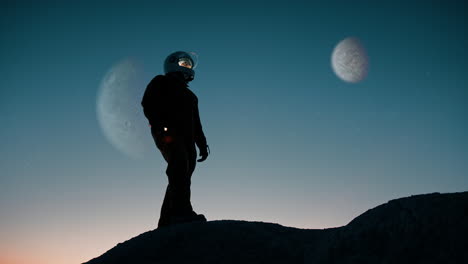 silhouette of an astronaut explores the mountain of an abandoned hostile planet