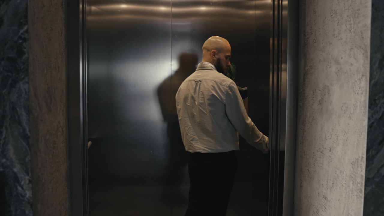Man moving with box in elevator
