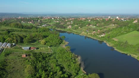 view over lake and houses in grassy woodland