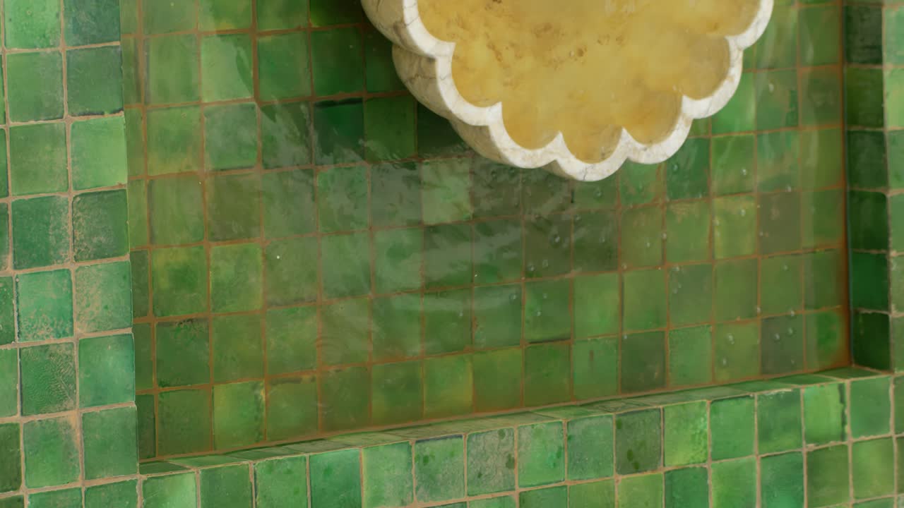 Traditional Moroccan fountain with green tiles in Marrakesh