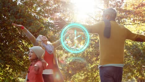 Neon-blue-digital-clock-ticking-against-caucasian-family-playing-in-the-park