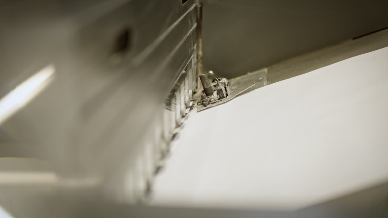 Close up of the printing machine, paper traveling on the production line, smal part of the machine moving