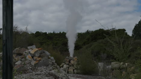 steam coming out of rocks at hells gate, rotorua, new zealand.