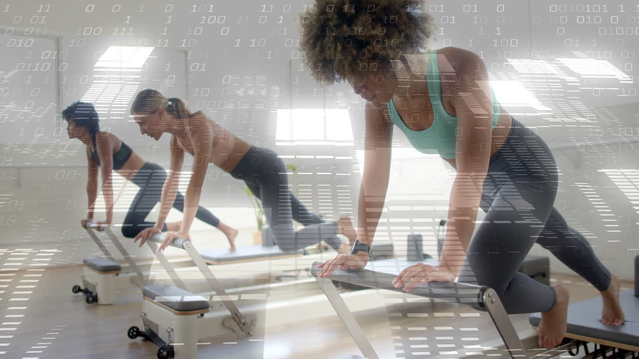 Women exercising on reformer machines with digital data overlay animation