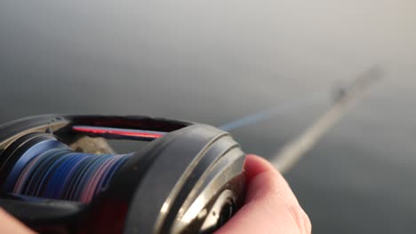 Close-up-of-fishingrod-near-water