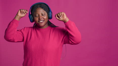 female wearing headphones and dancing