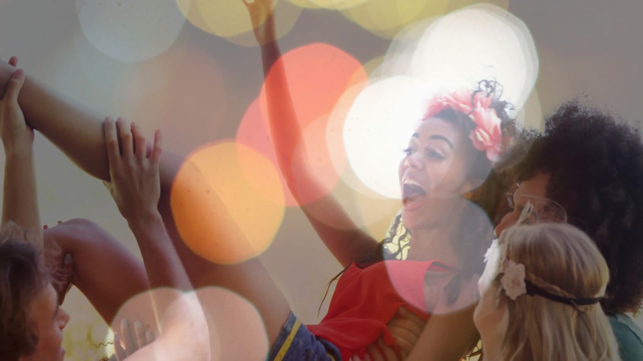 Friends initiating lift, carrying laughing woman, celebrating party, bokeh overlay softening faces