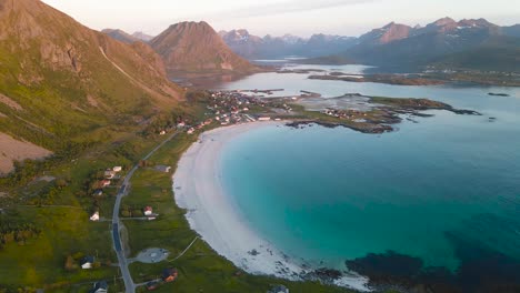 Aerial-view-of-Ramberg-beach-bay-with-mountains-landscape-in-the-background