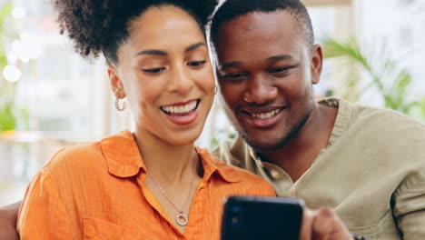 Phone,-couple-and-laughing-in-home-living-room