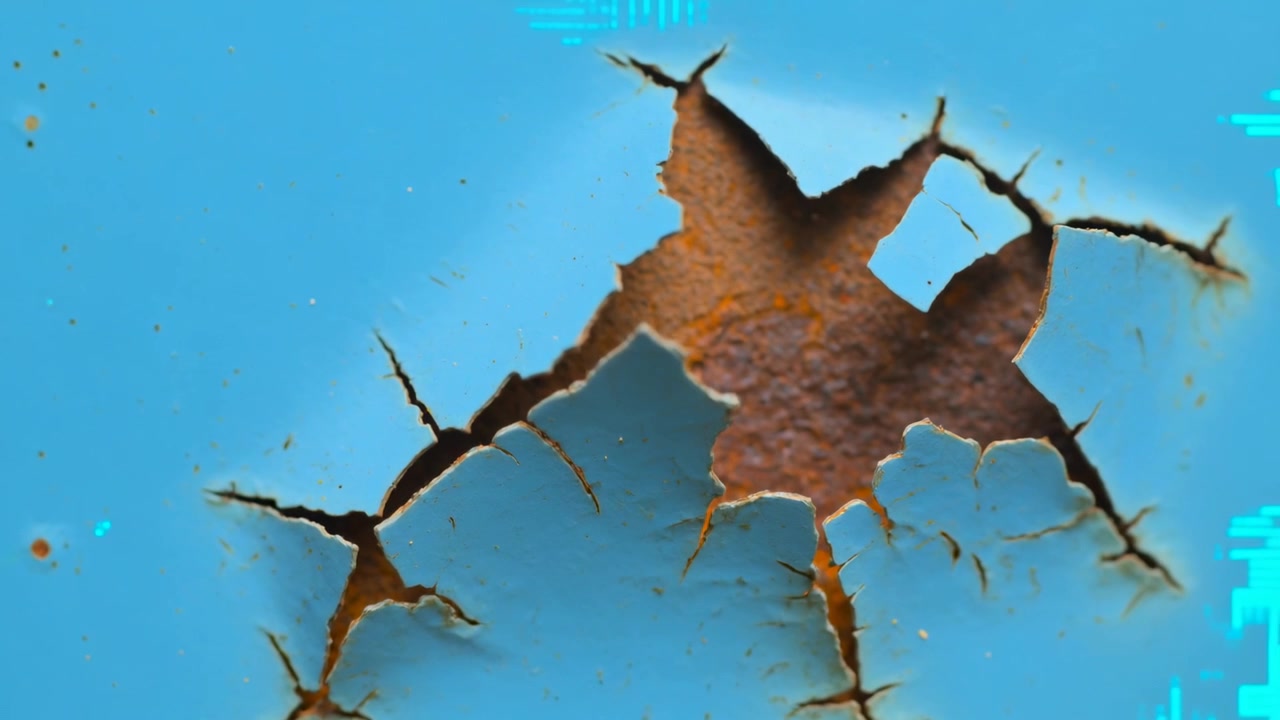 Camera zooming in, revealing peeling corroded spot on blue metal panel to show corrosion detail