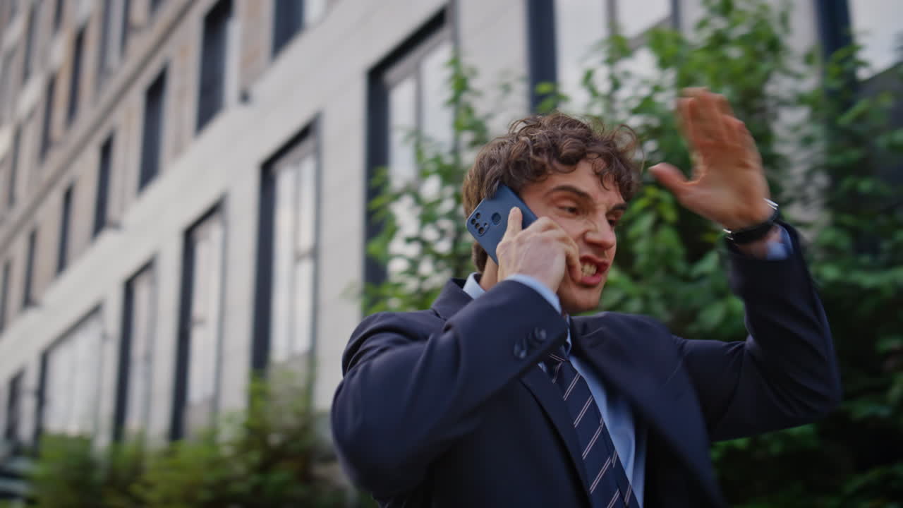 Walking entrepreneur yelling smartphone frustrated problem at street closeup