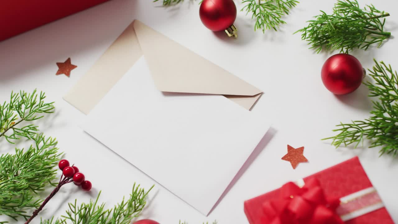 Hand-drawn strokes sliding from top-left building MERRY CHRISTMAS over flat-lay for holiday card