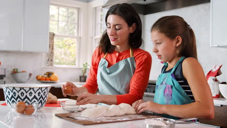 Jewish-mother-break-an-egg-for-glazing-challah-bread