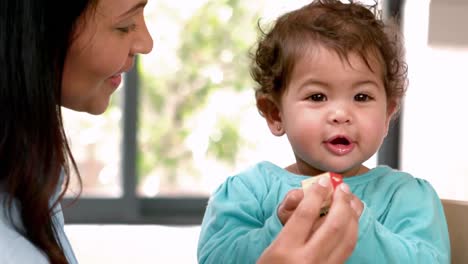 mother and her baby playing with wooden toy