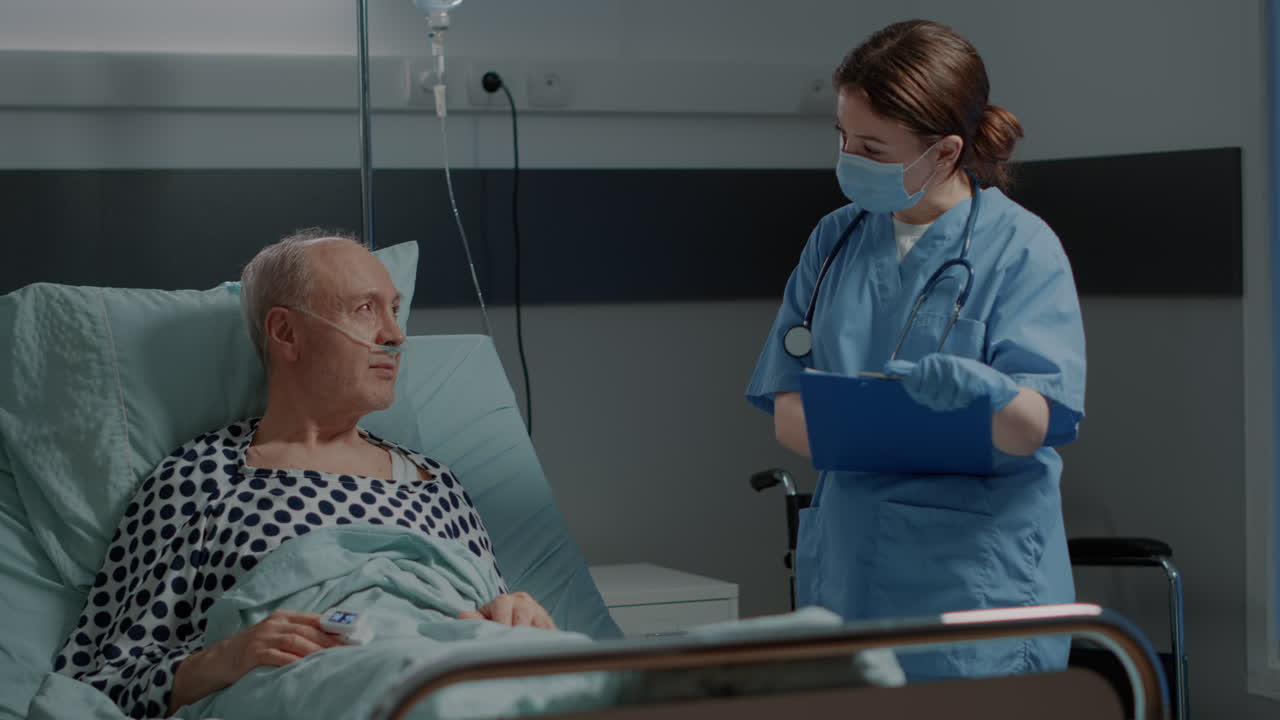 Hospital ward nurse checking on sick patient