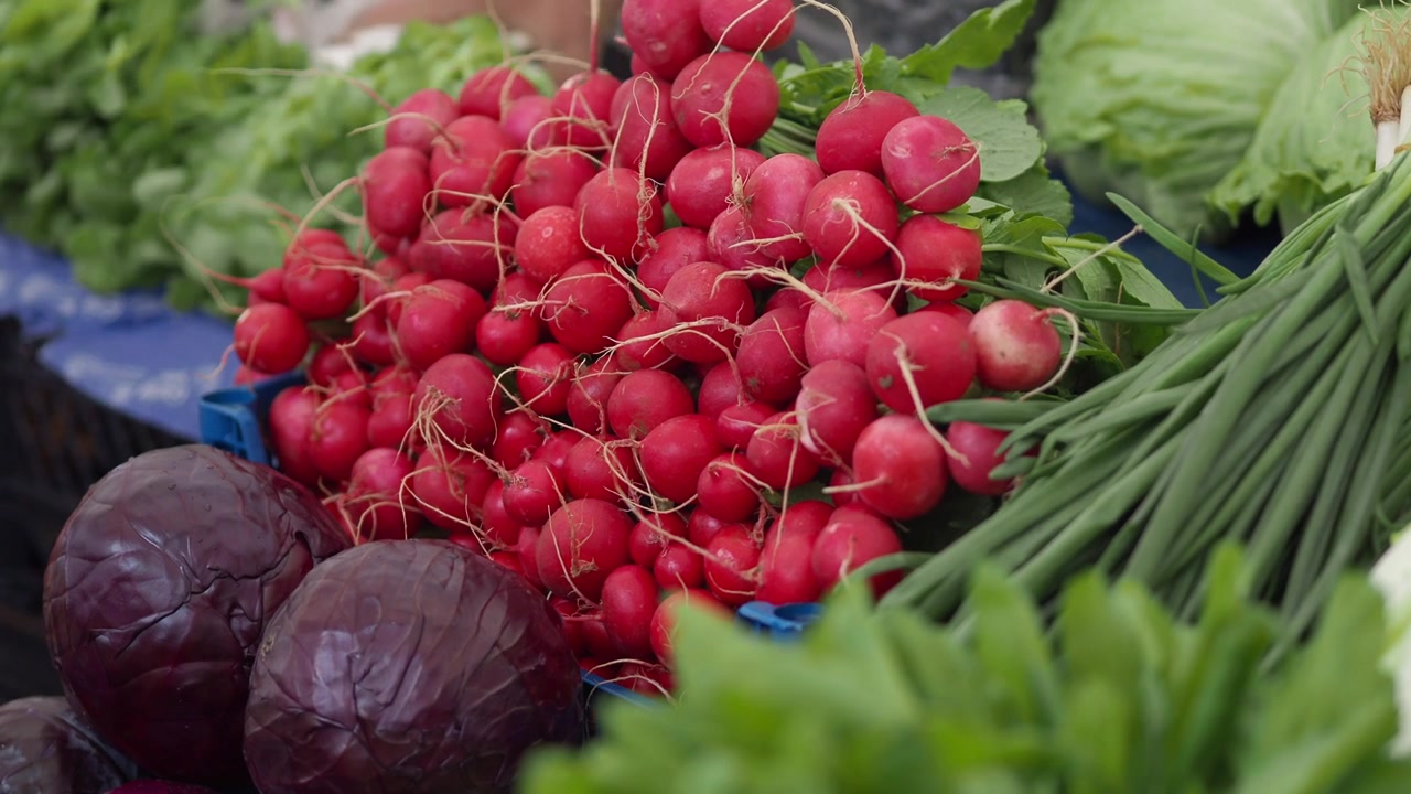 Fresh Radishes and Assorted Vegetables at a Farmers Market