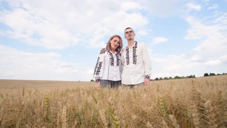 a ukrainian couple in embroidered dresses sings a song in the middle of a wheat field a ukrainian couple in embroidered dresses sings a song in the middle of a wheat field ukrainian patriots