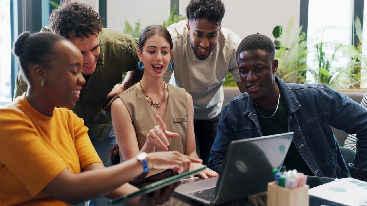 Diverse Group of Young Professionals Collaborating on Laptop in Modern Office
