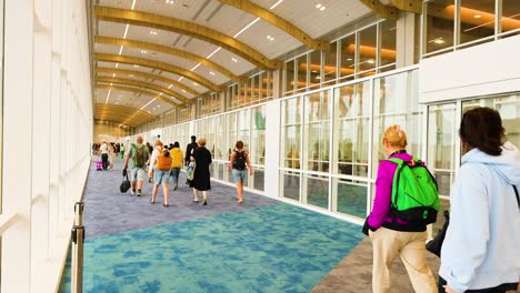 travelers move through a modern airport hallway