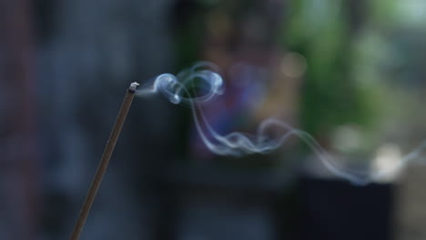 smoke gracefully rising from a burning incense stick