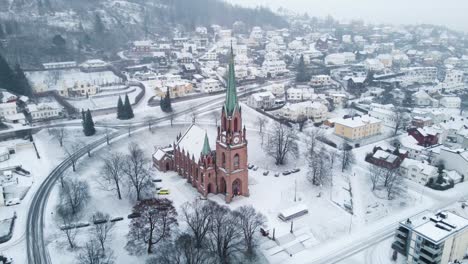 panoramic view of the old bragernes kirke cathedral in the center of dramen during snowfall