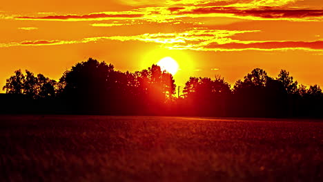 timelapse captures the radiance of a yellow sky above farmland, as clouds gracefully sweep by in latvia