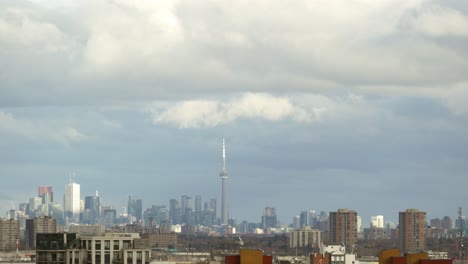 TIME-LAPSE---Storm-clouds-over-panorama-of-Toronto,-Ontario,-Canada,-wide-shot