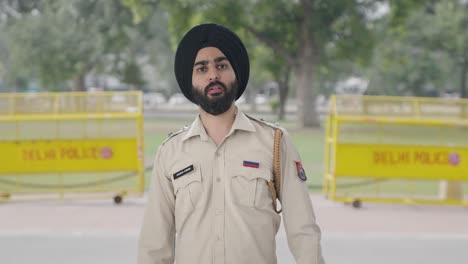 angry sikh indian police man pointing and calling someone