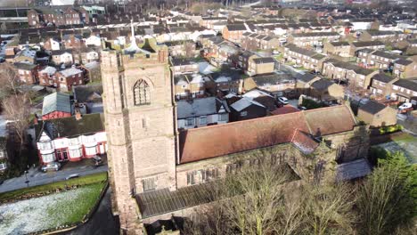 aerial rotate left view industrial small town frosty church rooftops neighbourhood north west england