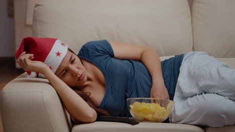 Close up of woman falling asleep while watching television
