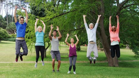 group of people exercising together in the park