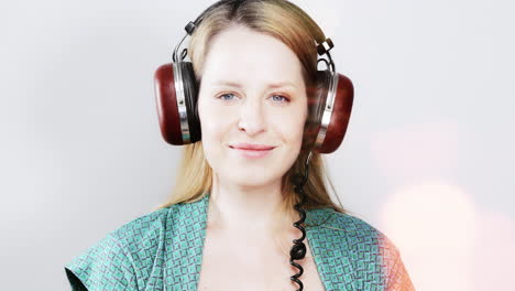 cool female dancer with changing retro headphones to listen to music