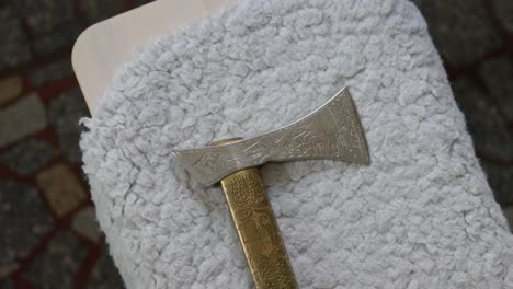 medium detail shot of shepherd's axe, long slim light combat axe of eurasian with wooden handle and carved decoration old traditional historical tool