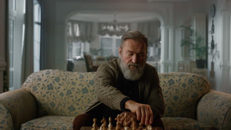 old aged man playing chess board alone at home. wisdom retirement life concept