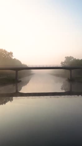 misty river bridge at sunrise/sunset