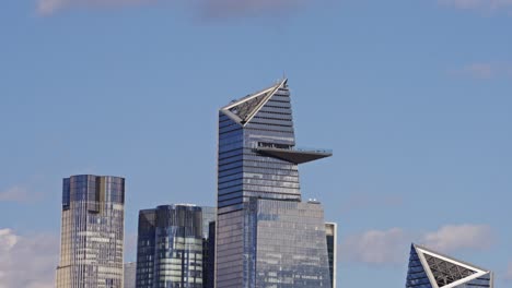 close-up of the edge observation deck at hudson yards, one of new york city’s tallest skyscrapers, under a clear blue sky