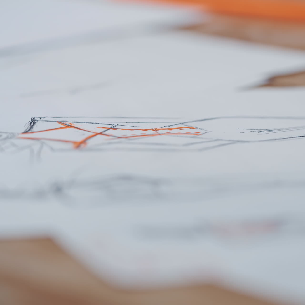 Many white sheets of paper with sketches of modern designes on the table. Ready drawings written on papers for fashionable clothes. Drawing and craft design.