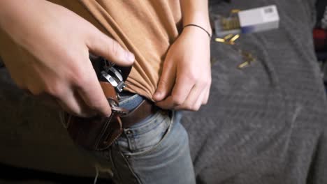 60p-slomo: drawing semi-automatic handgun from leather hip outside waistband holster