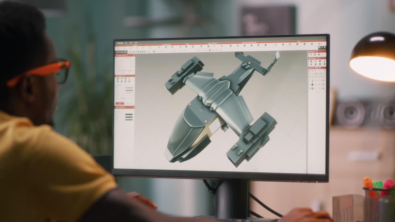Person Designing Aircraft Model on Computer