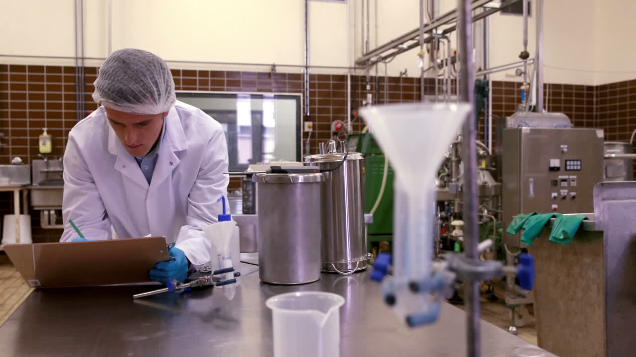 Brewery worker checking the product