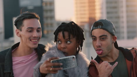 happy group of friends posing for selfie photo enjoying rooftop party celebration having fun making faces sharing weekend in city on social media