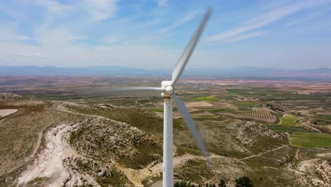 wind turbine rotating in a vast landscape